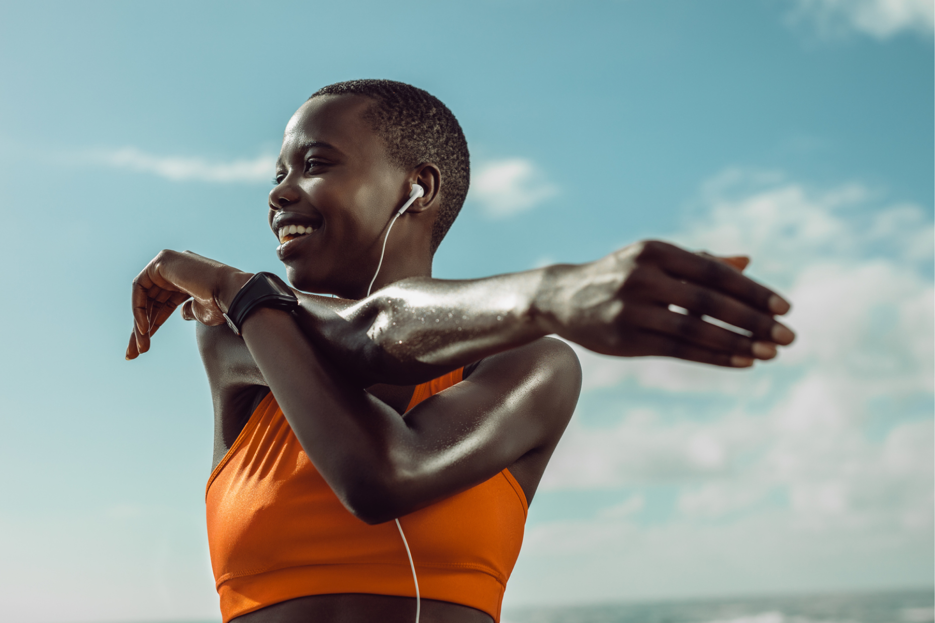 Woman with glowing, healthy skin exercising outdoors, showcasing the benefits of exercise for improved skin health and radiance.