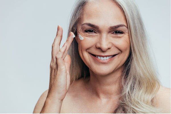 A woman using retinol skincare for her menopausal skin